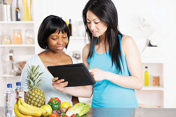 nutritionist working with client on Ipad