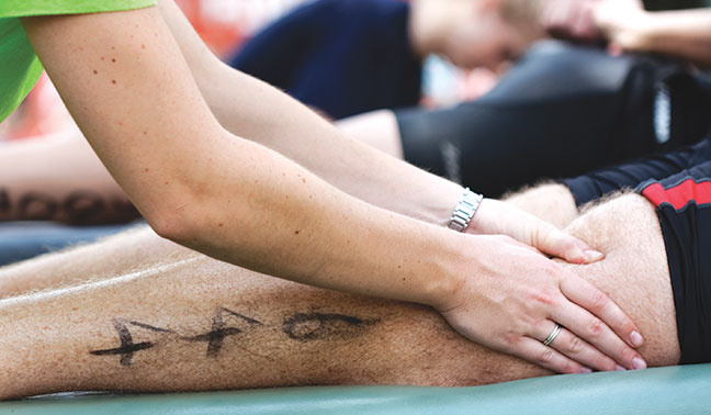 physiotherapist uses active release technique runners thigh