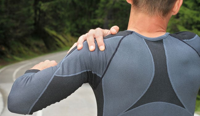 man holding a sore shoulder