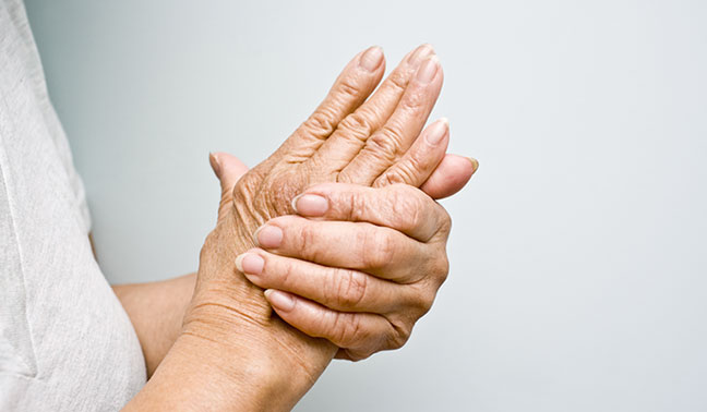senior woman close up hand rubbing hand arthritis