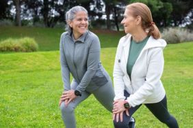 2 women stretching in a park