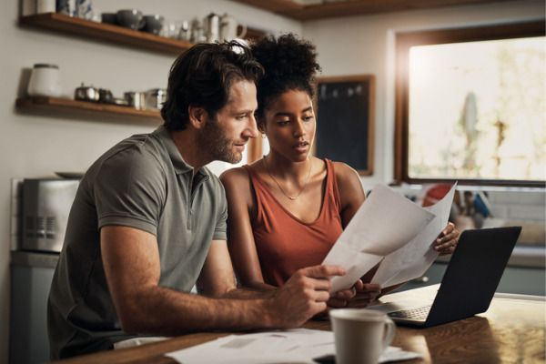 a couple reviewing their financial statements in their kitchen