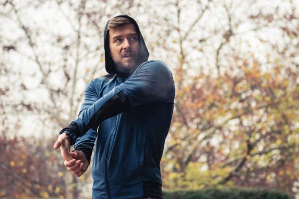 male runner stretching