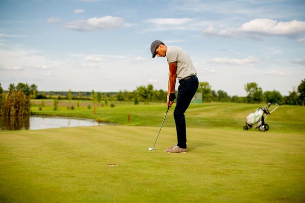 A man out in the golf course in the summer
