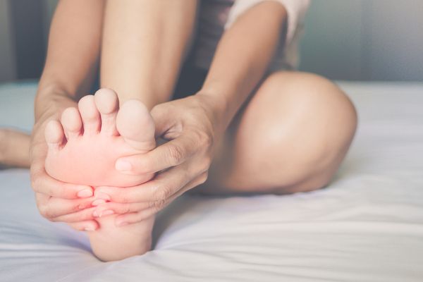 A woman rubbing her feet in pain 