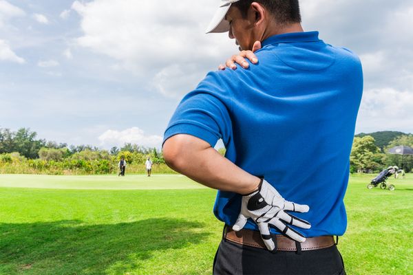 a man experiencing back pain due to golf