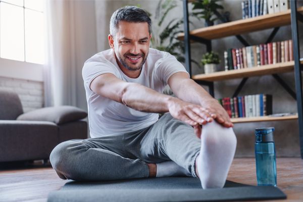 a man doing a hamstring stretch at home