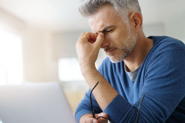 A man with a headache in a room 