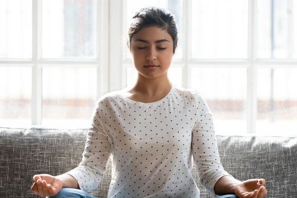 a woman practicing meditation at home