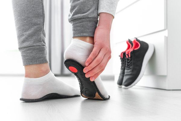 a photo of an orthotic being fitted on a foot