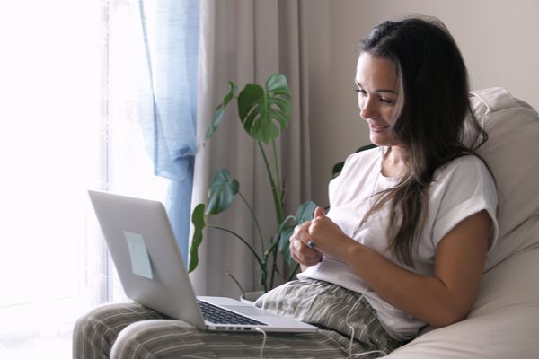 woman on a couch using her computer 