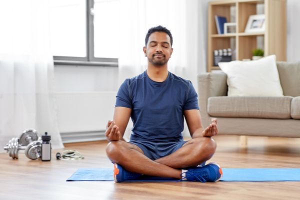 A man practicing calm breathing at home