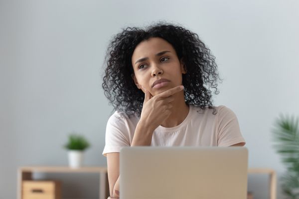 a woman thinking pensively at home 