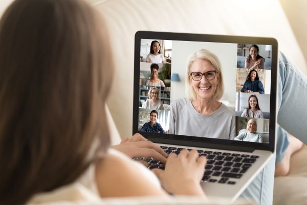 woman socializing with family and friends on zoom 