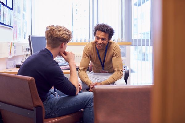 a young man and a councellor in an office