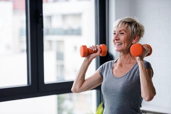 a woman lifting weights at home