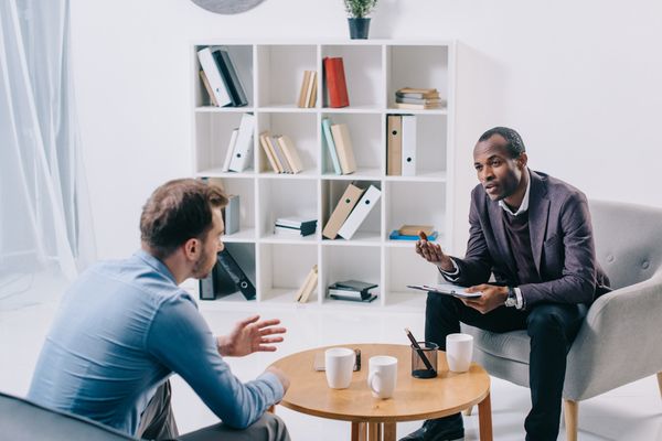 A psychiatrist talking to young male client