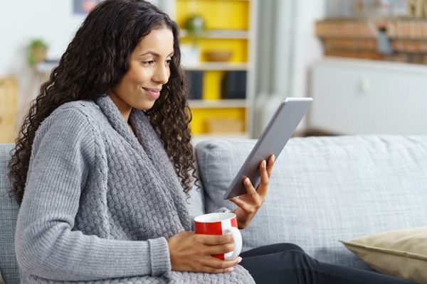 woman with tea and tablet