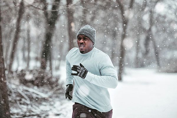 Man running in the winter in the woods Man running in the winter in the woods