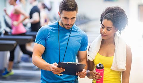 physiotherapist with patient in gym exercise plan