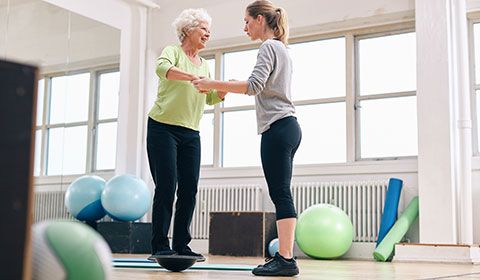 therapist working with a patient on balance exercises