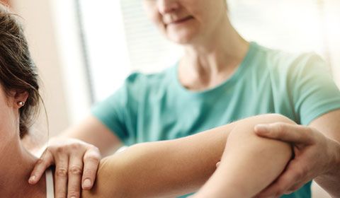 a women testing her shoulder's range of motion