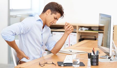 young man at desk lower back pain