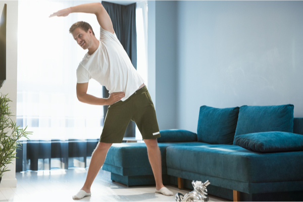 a man doing stretches at home
