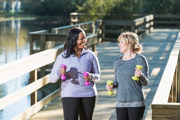 women walking with weights