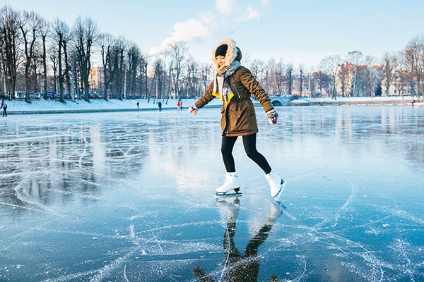 woman skating on outdoor pond