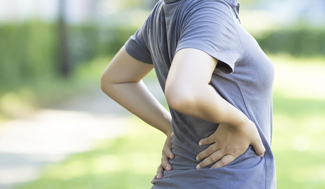 Woman outdoors with lower back pain
