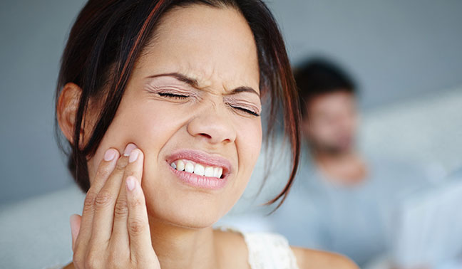 Women holding a sore jaw