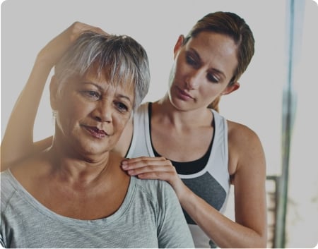 A female chiropractor working on an elderly lady
