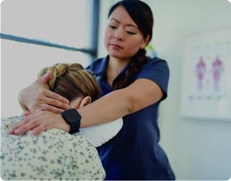 A woman massaging the back of another womans neck