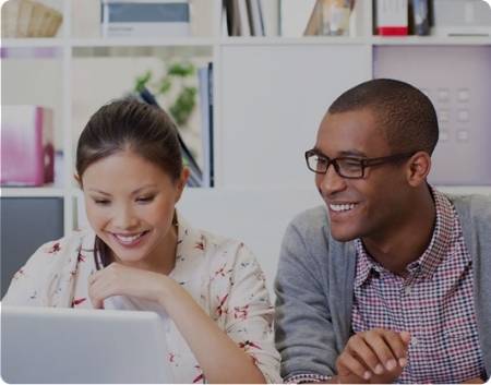 A man and a women reading on the computer