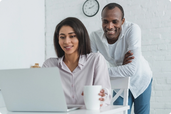 A couple looking at the computer together