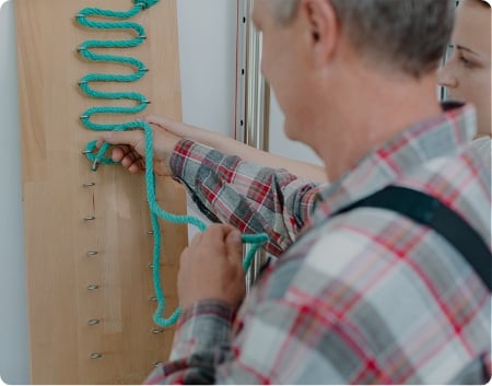Occupational Therapy - Man connecting a rope