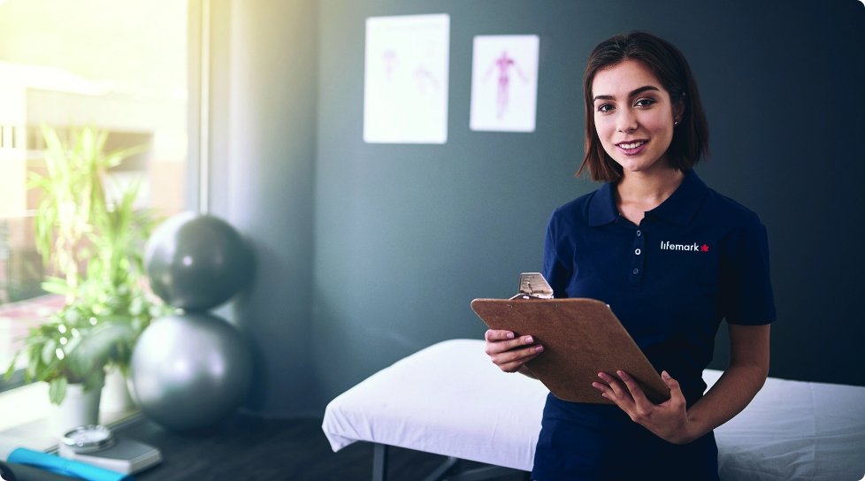 A woman in a blue lifemark shirt holding a clipboard