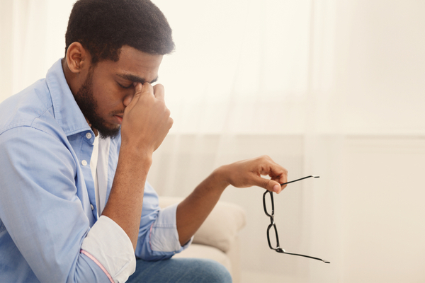 young man experiencing dizziness and a headache