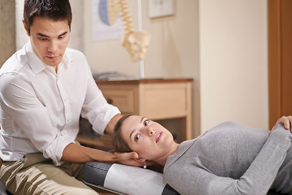 woman having neck assessed woman having neck assessed