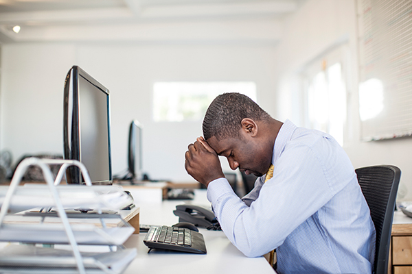 Man with concussion at desk Man with concussion at desk