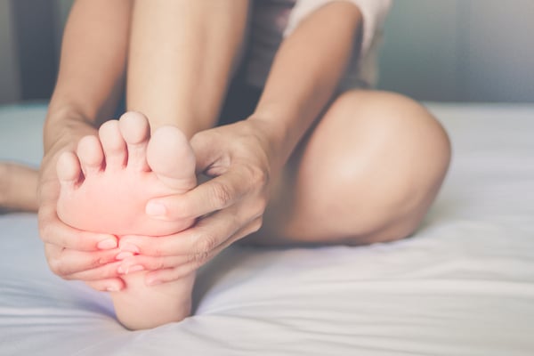A woman rubbing her feet in pain 