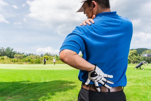 a man experiencing back pain due to golf