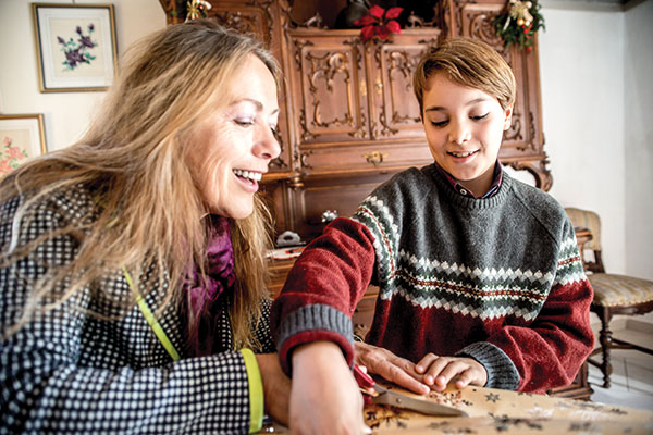 Mother and son wrapping presents together Mother and son wrapping presents together