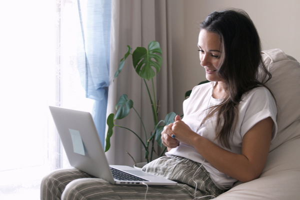 woman on a couch using her computer