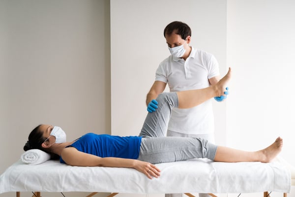 a physiotherapist performing treatment in a clinic.