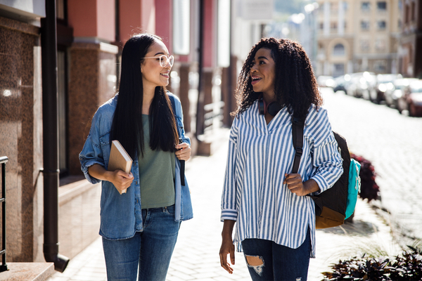 two women walking outdoors