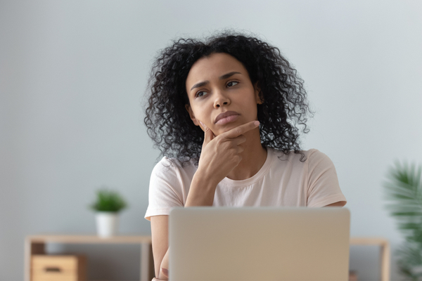 a woman thinking pensively at home