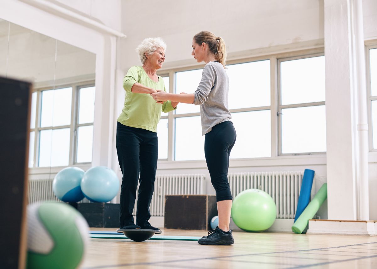 Senior woman receiving treatment for balance and BPPV with physiotherapist