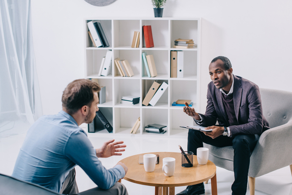 A psychiatrist talking to young male client
